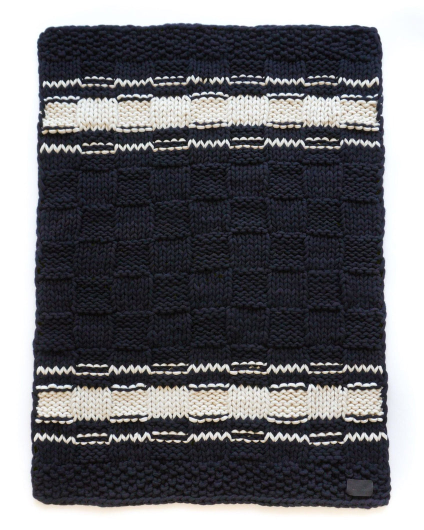 Black and ivory striped pure cashmere chunky knit blanket in a checkered square knit pattern. 